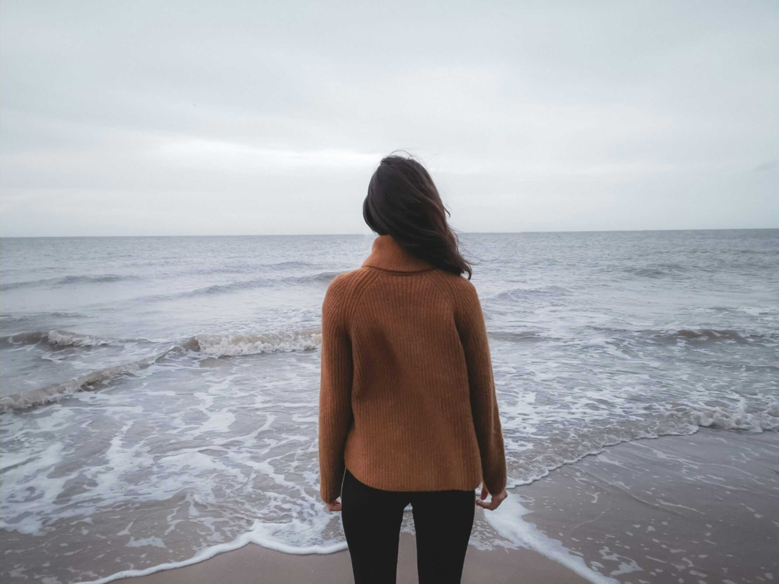 A woman standing in front of the sea