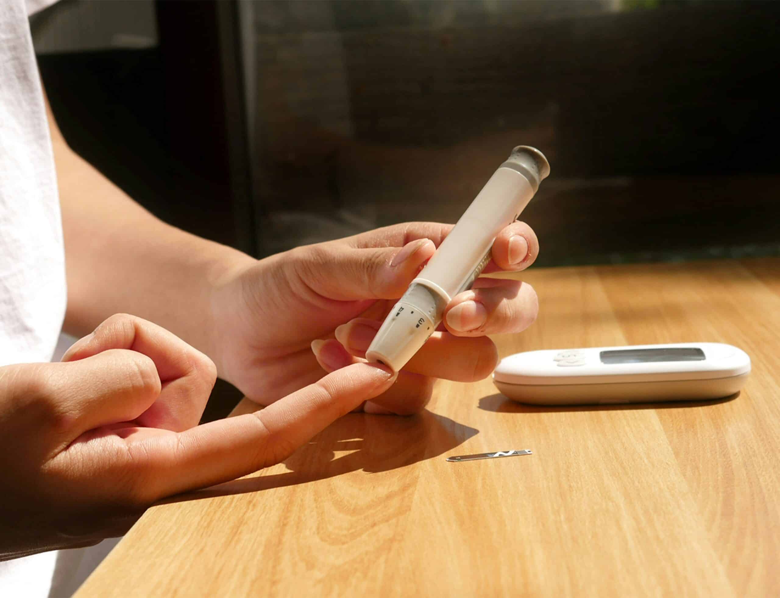 hands measuring blood sugar level